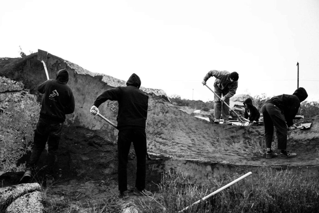 men working with shovels black and white